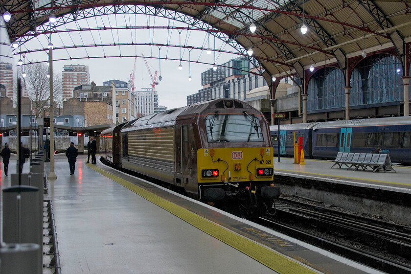 67021, outward leg of the Belmond British Pullman, 11.03 London Victoria-Gillingham (1Y40, 1E), London Victoria station 
 The Belmond Pullman is a regular fixture of London Victoria station and always occupies Platform two as seen here. As the crew prepares for the passengers to board the train dedicated Belmond 67021 idles on the rear of the charter. The train was an out-and-back charter running, rather unusually as 1Y40, which does not differentiate it as a special working. Leaving at 11.03 the appropriately dressed passengers would enjoy a slap-up lunch and later afternoon tea taking a return trip to Gillingham. 
 Keywords: 67021 Belmond British Pullman 11.03 London Victoria-Gillingham 1Y40 London Victoria station