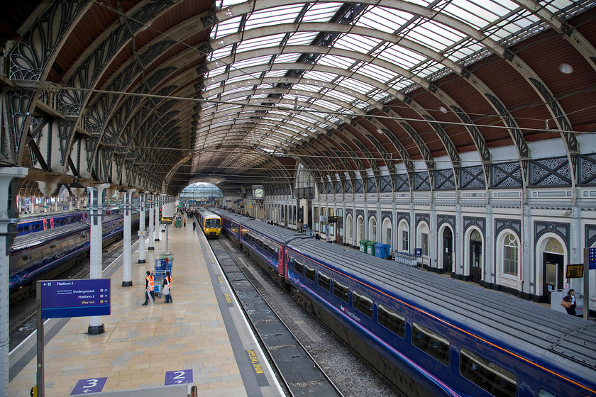 Class 43s & Class 165, GW 13.50 London Paddington-Oxford (1D39), London Paddington station 
 An iconic scene that is, unfortunately, set to change in the coming few months as the electrification of the GWML continues. Whilst the wiring has reached the northern side of the station the south side is totally unobscured and largely as it has been since opening in in 1854. In this view from the passenger footbridge, HSTs dominate the vista as they have done for nearly forty years now. Sitting and looking a little overwhelmed by everything is a Turbo Class 165 that is about to depart for Oxford as the 13.50 1D39 service. 
 Keywords: Class 43s Class 165 13.50 London Paddington-Oxford 1D39 London Paddington station First Great Western HST Turbo