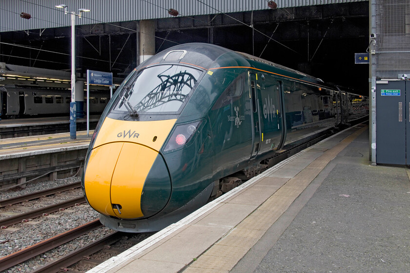 802101, 14.06 London Euston-North Pole Depot (5Q85, 4E), London Euston station 
 Not a sight seen very often; a GWR IET pokes its nose out from under the roof of London Euston station! 805101 'Nancy Astor' will work the 5Q85 14.06 Euston to North Pole Depot, one of a number of runs throughout the week to test if the bi-mode IETs can be utilised to operate some GWR services next Christmas during the eighteen-day closure of the GWML into Paddington. Staff told me that they had been given this set for the week in order to undertake various logistical and gauging tests and that so-far, things had gone well. They had also run into Waterloo to see if this station could be used too. 
 Keywords: 802101 14.06 London Euston-North Pole Depot 5Q85 London Euston station GWR IET Nancy Astor