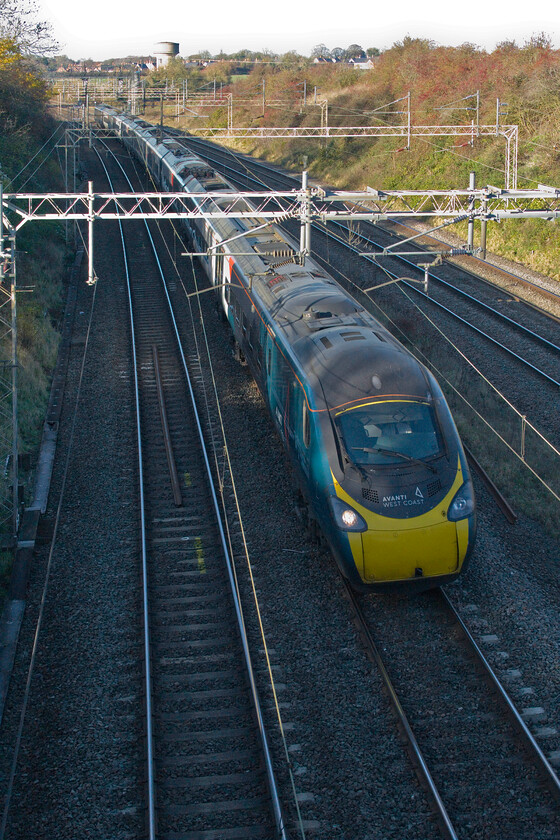 390005, 08.38 Glasgow Central-London Euston (1M09, 10L), Victoria bridge 
 Unfortunately, the low winter afternoon sunshine has plunged the fast lines that pass through a low cutting between Roade and Ashton on the southern WCML into shadow. The wide tonal range of modern digital cameras has enabled a passing photograph of 390005 'City of Wolverhampton' working the 08.38 Glasgow Central to Euston to be presented. 
 Keywords: City of Wolverhampton 390005, 08.38 Glasgow Central-London Euston (1M09, 10L), Victoria bridge