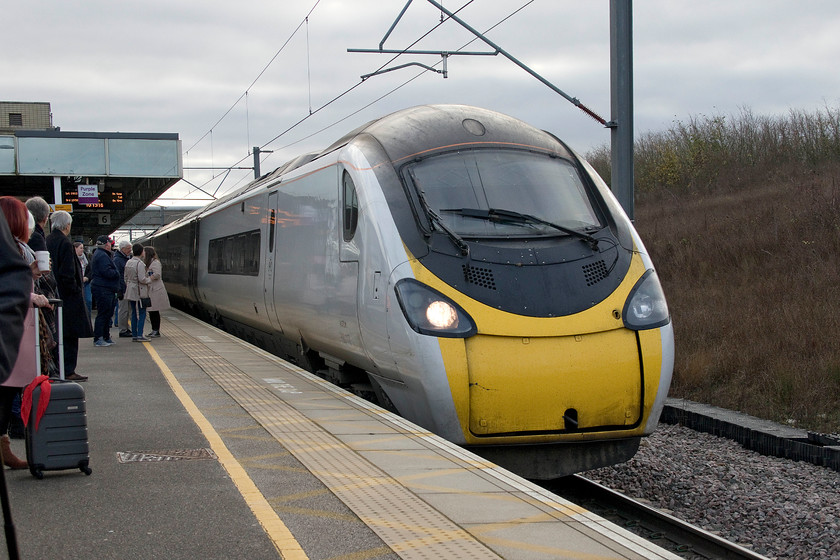 390117, VT 09.43 London Euston-Glasgow Central (9S55, 4L), Milton Keynes Central station 
 390117 'Blue Peter' arrives at Milton Keynes station working the 09.43 Euston to Glasgow Central 9S55 service. My wife and I took this service as far as Birmingham New Street making it our final journey with Virgin Trains. The driver took the opportunity to blow his horn passing every station to herald the end of the Virgin franchise and the end of a twenty-two-year era of a post nationalisation railway. 
 Keywords: 390117 09.43 London Euston-Glasgow Central 9S55 Milton Keynes Central station Blue Peter Virgin Trains Pendolino