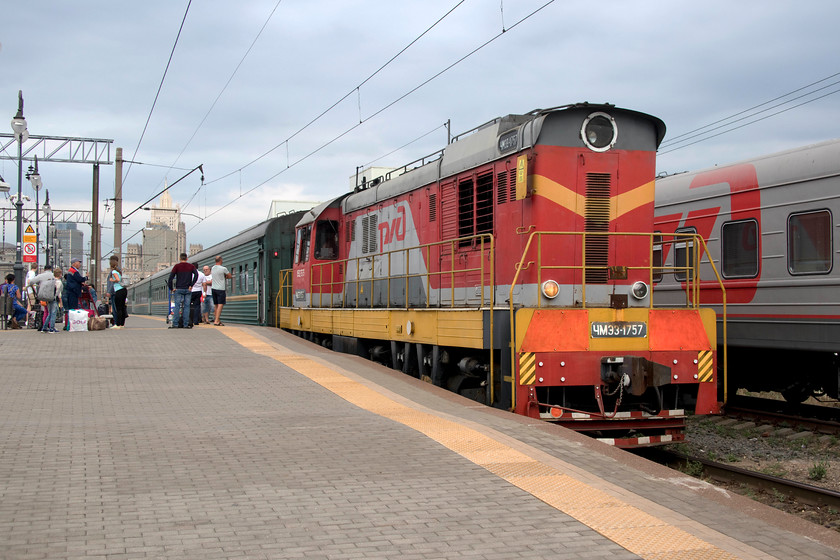 CMZ3-1757, station pilot on ECS duties, Moscow Kiyevsky station 
 With the weary passengers having disembarked from the recent arrival from the Moldovan capital, Chisinau, the empty coaching stock is about to be removed to the sidings by CMZ3-1757. The green stock is in the colours of Moldovan Railways that looked as though it would need a thorough clean and preparation before returning having been in use for the previous twenty-four hours! In the background here at Kiyevsky station is the classic Soviet-era Ministry of Foreign Affairs building located on Smolensk Square complete with its illuminated red star atop the spire. 
 Keywords: CMZ3-1757 station pilot on ECS duties Moscow Kiyevsky station