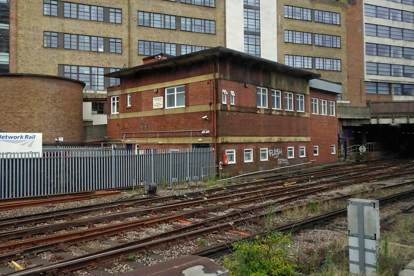 Victoria Central signal box, closed (SR, 1939) 
 Built and commissioned on 04.06.39, just two months prior to the outbreak of WWII Victoria Central signal box was the height of modernity both in terms of its design and its operations. It operated a Westinghouse Brake & Signal Co. Ltd. style 'L' power lever frame in common with much of the Southern's operations at the time. I closed on 17.05.80 with control moving to the Victoria signalling centre located at Clapham Junction. It's surprising that the box has not been demolished given the shortage of space around Victoria station but it appears to be in use today by Network Rail. This photograph is taken from our train as it enters Victoria station. 
 Keywords: Victoria Central signal box