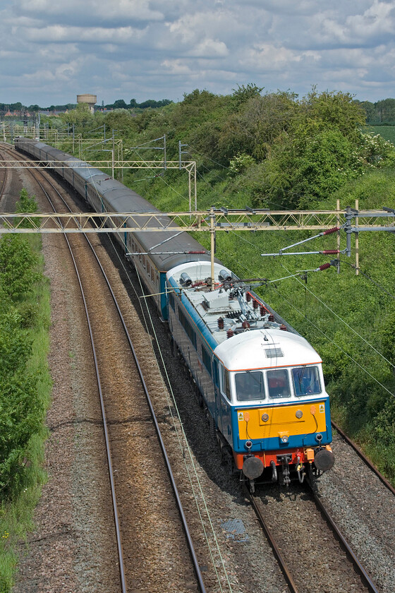 86259, 08.41 Manchester Piccadilly-Wembley Central (1Z84, 1E), Victoria bridge 
 I am more usually used to photographing 86259 'Les Ross/Peter Pan' heading north leading the regular Winter/Cumbrian Mountain/Coast Express charters but here it is heading south at Victoria bridge just south of Roade. On this sunny spring morning, it is leading the 1Z84 08.41 Manchester Piccadilly to Wembley Central footex charter operated by LSL. The charter is taking supporters from Manchester for the FA Cup Final that would see a surprising result with United beating City 2-1. 
 Keywords: 86259 08.41 Manchester Piccadilly-Wembley Central 1Z84 Victoria bridge AL6 Les Ross Peter Pan