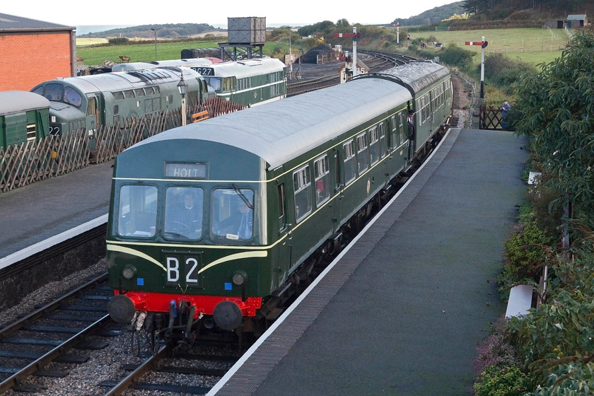 M51192 & M56352, 11.20 Sheringham-Holt, Weybourne station 
 The 10.30 Sheringham to Holt service arrives at Weybourne station. It is formed by one of the North Norfolk Railway's resident class 101 DMUs, in this case, M51192 and M56352. In the background, the busy Weybourne yard is in view. D6732 (37032) and D5631(31207) are stabled in the bay platform in front of a SR GUV that homes the NNR's model railway exhibition. 
 Keywords: M51192 M56352 11.20 Sheringham-Holt Weybourne station