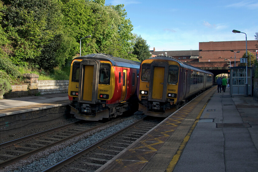 156497, EM 18.14 Matlock-Nottingham (2A37, 1E) & 156922 EM 17.54 Nottingham-Matlock (2A32, RT), Belper station 
 A crossing of services takes place at Belper station. To the left 156497 pauses with the 18.14 Matlock to Nottingham 2A37 EMR service. Meanwhile, to the right 156922 is waiting for the RA with the 17.54 Nottingham to Matlock balancing working. After a day of avoiding torrential rain showers, it's ironic that the sun is in the ascendency with a glorious sunset later in the evening! 
 Keywords: 156497 18.14 Matlock-Nottingham 2A37 156922 17.54 Nottingham-Matlock 2A32 Belper station EMR East Midlands Railway