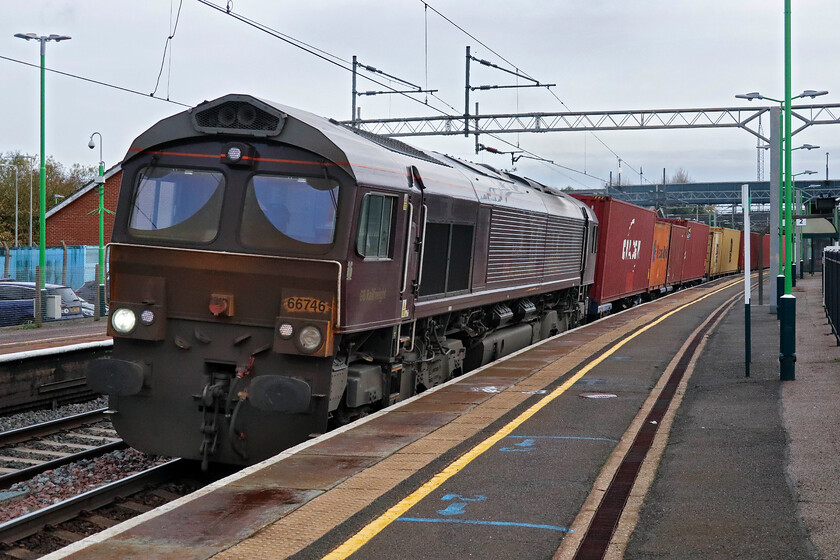 66746, 10.36 Felixstowe North-Trafford Park (4M22, 2L), Wolverton station 
 How the mighty have fallen! Usually, kept immaculate for its special Royal Scotsman duties GBRf's 66746 looks in a terrible state hauling the 4M22 10.36 Felixstowe to Trafford Park service. In this condition, it can only have been operating an RHTT service along with another equally dirty Class 66 no doubt. I am surprised that the locomotive was passed fit for service with its high-intensity yellow front completely lost beneath a layer of filth with just the area around the number and the headlights wiped clear prior to departure. 
 Keywords: 66746 10.36 Felixstowe North-Trafford Park 4M22 Wolverton station GB Railfreight Royal Scotsman