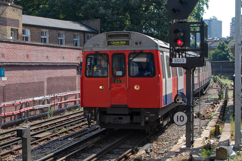 5711, CW Circle Line working to Edgware Road, High Street Kensington TfL station 
 A clockwise Circle Line working arrives at High Street Kensington station. I travelled aboard C69 5711 as far as Paddington station. This will probably be one of my final journeys on a C69 set with their withdrawal now well under way. 
 Keywords: 5711 Circle Line working to Edgware Road High Street Kensington TfL station C69