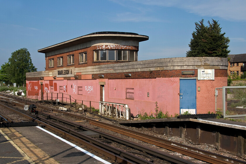 Wimbledon A signal box (SR, 1948) 
 Quite why the superb Wimbledon A signal box has been partially painted with some poor quality faded pink paint is somewhat of a mystery not helped by some vandalism and patching with paint of a different colour! The classic 1948 Southern structure is now one of a handful remaining including some on the TfL network. Often referred to as 'Odeon-style' these boxes are extremely elegant Art-Deco styled and would have been very modern and contemporary when opened. This example was used as an S & T school when it was closed but that work is no longer undertaken so its present-day use is limited. 
 Keywords: Wimbledon A signal box SR