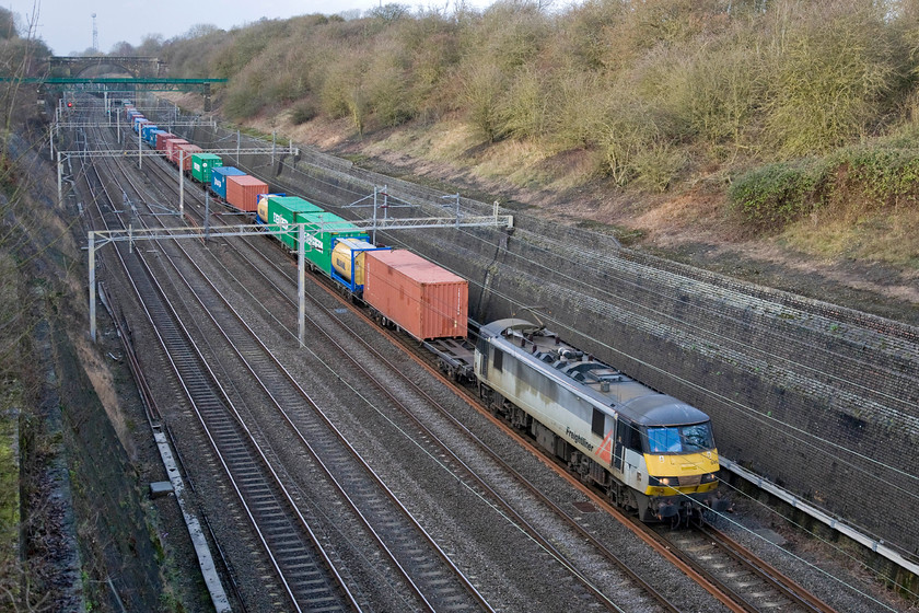 90047, 12.32 Crewe Basford Hall-Felixstowe North (4L96), Roade cutting 
 FREIGHT NUMBER FIVE - The sun is just trying to cut through the January gloom as 90047 climbs through Roade cutting leading the 12.32 Crewe Basford Hall to Felixstowe North intermodal service. Now twenty-four years old this Class 90 is looking a little tatty and dated in its Freightliner two-tone dark and light Grey livery. 
 Keywords: 90047 12.32 Crewe Basford Hall-Felixstowe North 4L96 Roade cutting Freightliner