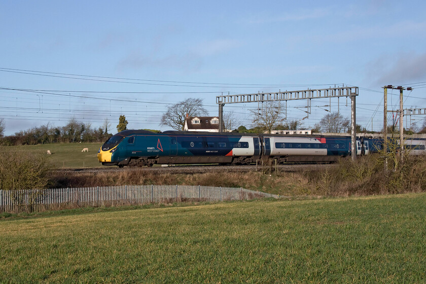 390155, VT 06.10 Manchester Piccadilly-London Euston (1A05, 3L), between Roade & Ashton 
 390155 'Pride and Prosperity' makes a fine sight in the early morning sunshine as it passes between the villages of Roade and Ashton on South Northamptonshire. Named back in December 2019 to mark the launch of Avanti's operations on the WCML taking over the mantle from the venerable Virgin it was working the 06.10 Manchester to Euston service. 
 Keywords: 390155 06.10 Manchester Piccadilly-London Euston 1A05 between Roade & Ashton Pride and Prosperity