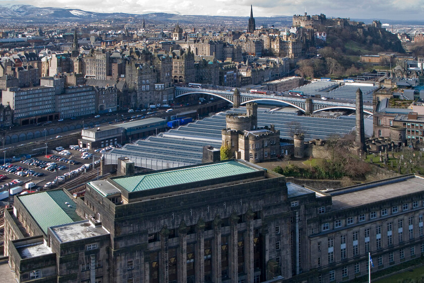 Edinburgh Waverley station from Calton Hill 
 This view of Waverley station shows its incredible location deep in a valley between the medieval Old Town and the eighteenth-century New Town most famous for Princes Street. This view clearly shows the new and vast glazing to the roof that has improved the interior ambience of the station. Its central location is a real boon to the millions of tourists who visit the city every year meaning easy access to their accommodation after arrival in the city. Notice also the snow covering the Pentland Hills in the distance, a reminder of how cold it was over this early Easter period. 
 Keywords: Edinburgh Waverley station from Calton Hill