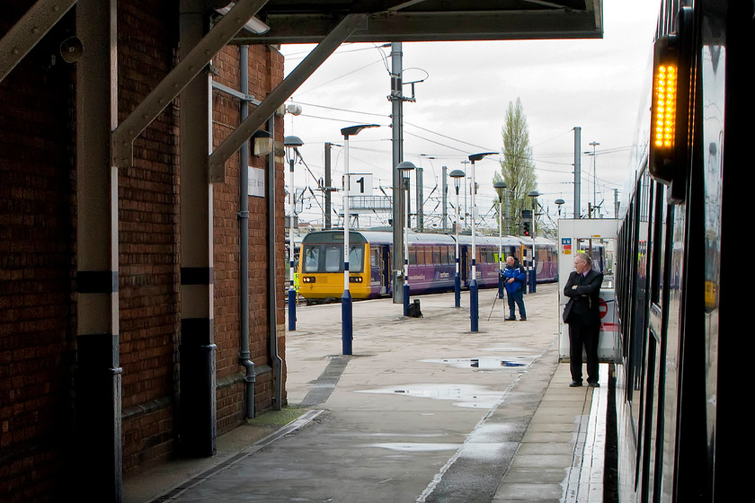 Class 142, 16.19 Scunthorpe-Lincoln (2P79), Doncaster station 
 A Pacer enters Doncaster station working the 2P79 16.18 Scunthorpe to Lincoln service. The image is taken from the door or the 13.30 Edinburgh Waverley to King's Cross hst that is preparing to leave the station. Despite it being the end of April, the weather was cold and grey. 
 Keywords: Class 142 16.19 Scunthorpe-Lincoln 2P79 Doncaster station Pacer