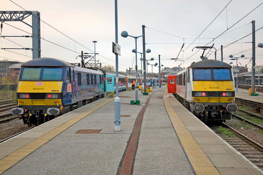 90034, LE 16.30 Norwich-London Liverpool Street (1P53) & 90011, LE 16.00 Norwich-London Liverpool Street (1P51), Norwich station 
 It's not even two hours since the previous picture was taken but what a change! High cloud has come in and the sun has all but gone; such is the fickle nature of the UK's weather! Waiting at Norwich station is a pair of Class 90s that will be heading for London's Liverpool Street within half an hour of each other. To the right, 90011 'East Anglian Daily Times Suffolk & Proud' will leave first with the 1P51 16.00 departure whilst 90034, hired in from Deutsche Bahn (DB), will lead the 1P53 16.30 train. 
 Keywords: 90034 16.30 Norwich-London Liverpool Street 1P53 90011, LE 16.00 Norwich-London Liverpool Street 1P51 Norwich station GA Greater Anglia East Anglian Daily Times Suffolk & Proud