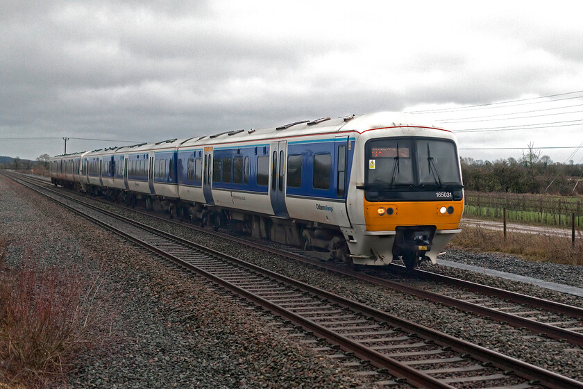 165013 & 165015, CH 08.12 London Marylebone-Oxford (1T12, RT), Oddington SP542160 
 165013 leads 165015 past Oddington between Oxford and Bicester working Chiltern's 08.12 Marylebone to Oxford train. Known by various names such as the Networker Turbo, the Chiltern Turbos or simply just Turbos these highly successful BREL (York) built units have been in operation for over thirty years throughout the western lines stretching from London to Birmingham to Portsmouth to Wales and more recently into deepest Cornwall. An enduring design of second-generation DMU that still have life in them yet with some even being experimentally turned into hybrid units. 
 Keywords: 165013 165015 08.12 London Marylebone-Oxford 1T12 Oddington SP542160 Chiltern Railways Turbo unit