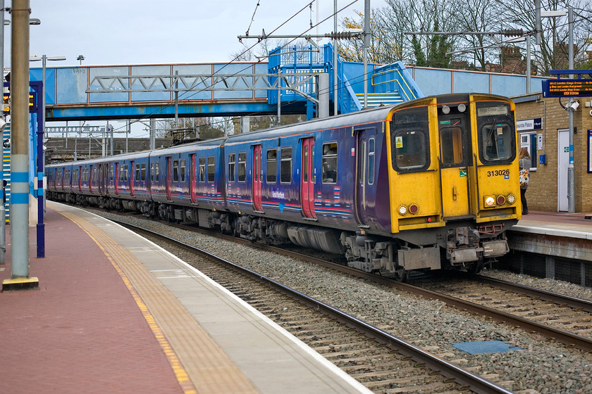 313026, GE 08.30 Stevenage-London King's Cross (2D17), Alexandra Palace station 
 313026 drifts into Alexandra Palace station's platform one. The train is working the 08.30 Stevenage to London King's Cross Great Northern train that will arrive at its destination in about twenty minutes time after stopping at all stations on the way. 
 Keywords: 313026 08.30 Stevenage-London King's Cross 2D17 Alexandra Palace station Great Northern