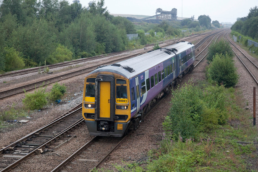 158861, NT 15.54 Hull-Doncaster (2C33, 2E), Hatfield & Stainforth station 
 In the late July murk at Hatfield and Stainforth 158861 'Magna Carta 800 - Lincoln 2015' passes with the 15.54 Hull to Doncaster Northern service. As with other units, this one still wears its Northern Rail livery but devoid of any branding. Unlike the lowly Pacers, these Sprinters are gradually being repainted (or vinyl wrapped) into the operators 'new' look. 
 Keywords: 158861 15.54 Hull-Doncaster 2C33 Hatfield & Stainforth station