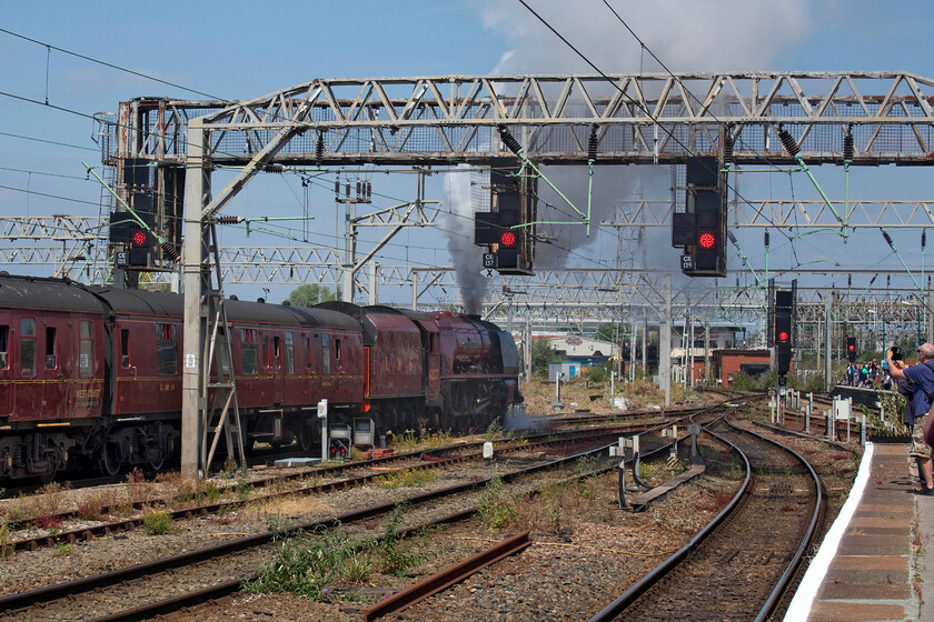 6233, outward leg of The Cheshireman, 06.39 London Euston-Chester (1Z86, 3E), Crewe station 
 I saw and photographed the outward leg of The Cheshireman charter earlier in the morning passing Roade. On arrival at Crewe Mike and I caught up with the train as it had been sitting at the station for some time waiting to leave for the final part of its journey to Chester. It is seen leaving Crewe now working more than it was earlier in the day when 47813 was doing nearly all the work at the rear of the train. Look at all the crowds on the platform end all eager to get their shot or video of the train departing. The majority of these enthusiasts would be attending DRS' Gresty Bridge open day. 
 Keywords: 6233 The Cheshireman 06.39 London Euston-Chester 1Z86 Crewe station Duchess of Sutherland LMS