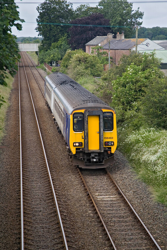 156483, NT 07.50 Barrow-in-Furness-Carlisle (2C41, 11L), Low. Row NY190449 
 With the cloud drifting in from the nearby coast on a brisk northwesterly wind the edge has been taken off the sun. 156483 rattles along the bullhead track near the hamlet of Low Row working the delayed 07.50 Barrow-in-Furness to Carlisle service. Whilst waiting for this train, Andy and I were entertained by the farmers making hay for silage to be consumed over the coming winter. 
 Keywords: 156483 07.50 Barrow-in-Furness-Carlisle 2C41 Low. Row NY190449 Northern