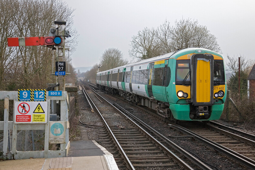 377402, SN 17.57 Bognor Regis-London Victoria, Pulborough station 
 377402 is seen arriving at Pulborough station working Southern's 17.57 Bognor Regis to London Victoria service. It is passing the station's down starter upper quadrant semaphore (PH27) that is controlled by the 1878 signal box located at the other end of the station. This semaphore and the others seen in the distance will soon be wiped away as another section of absolute block is removed from the network in the endless pursuit of moderation. 
 Keywords: 377402 17.57 Bognor Regis-London Victoria Pulborough station Souther Electrostar