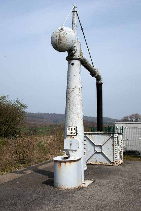 Water column, Battersby station 
 The water column at Battersby station has been a feature for well over one hundred years according to its NER plate. It's a reminder of days past when steam train boilers would be replenished on arrival at the station that was a much busier place that it is today. Notice the electrical relay room at the end of the platform, just beyond this used to be the impressive signal box that controlled all movements in and out of the station. Today, there is a token cabinet on the platform where the driver will exchange the token to continue their journey to either Middlesborough or Whitby under the authority of the signalmen at Nunthorpe. 
 Keywords: Water column Battersby station