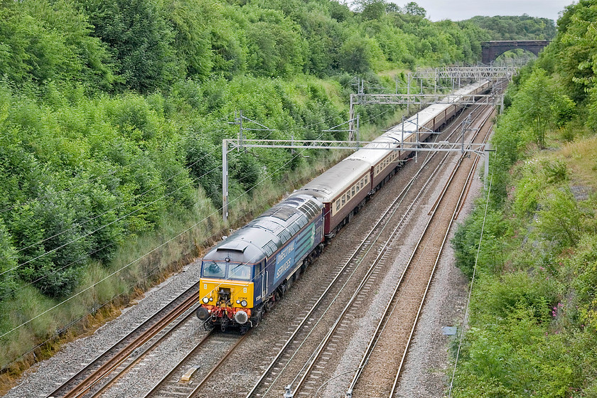 57304, outward leg of British GP special, London Euston-Milton Keynes-Rugby-Milton Keynes (1Z64), Hyde Road bridge 
 Having picked up some passengers at Rugby, 57304 'Pride of Cheshire' leads the Northern Belle Grand Prix special south through Roade cutting seen from Hyde Road bridge. The passengers will alight at Milton Keynes and be conveyed the relatively short distance to Silverstone by a fleet of busses. The train will then travel to Bletchley and be stabled for the rest of the day. 
 Keywords: 57304 British GP special, London Euston-Milton Keynes-Rugby-Milton Keynes 1Z64 Hyde Road bridge Pride of Cheshire DRS Northern Belle