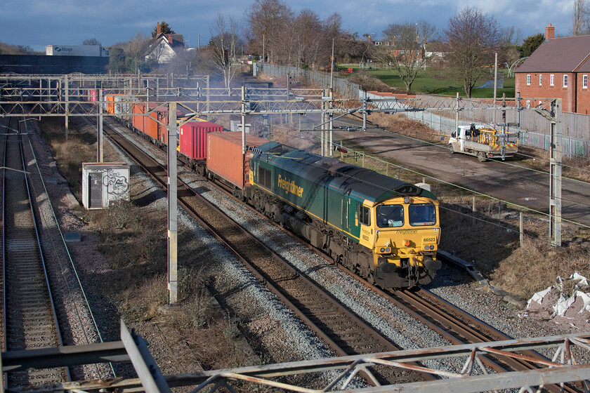 66523, 12.16 Lawley Street-London Gateway (4L46, 4L), site of Roade station 
 With a particularly smokey exhaust, 66523 looks as if it needs some attention as it lays a blue haze across Roade leading the 12.16 Lawley Street to London Gateway Freightliner. With the security of the railways appearing to be Network Rail's obsession it is therefore surprising that the large access gate at the top of the photograph next to the former station master's house is wide open and remained so for the duration of the day and over the following weekend but with no railway staff in attendance. 
 Keywords: 66523 12.16 Lawley Street-London Gateway 4L46 site of Roade station Freightliner