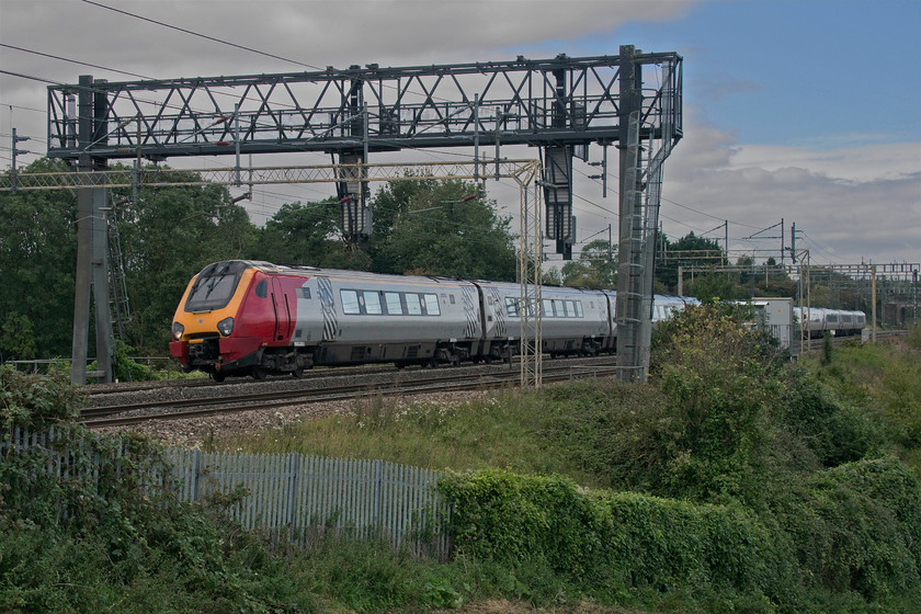 221143 & 221101, VT 13.14 Coventry-London Euston (1B24, 4E), Roade Hill 
 In tricky lighting 221143 'Auguste Picard' and 221101 '101 Squadron' heads south between Roade and Ashton working Avanti West Coast's 13.14 Coventry to Euston 1B24 service. With engineering works closing the line at Birmingham International all Avanti and London NorthWestern West Midland services were terminating at and starting from Coventry with the dreaded 'bustitution' from there. 
 Keywords: 221143 221101 13.14 Coventry-London Euston 1B24 Roade Hill Voyager Avanti West Coast 101 Squadron Auguste Picard