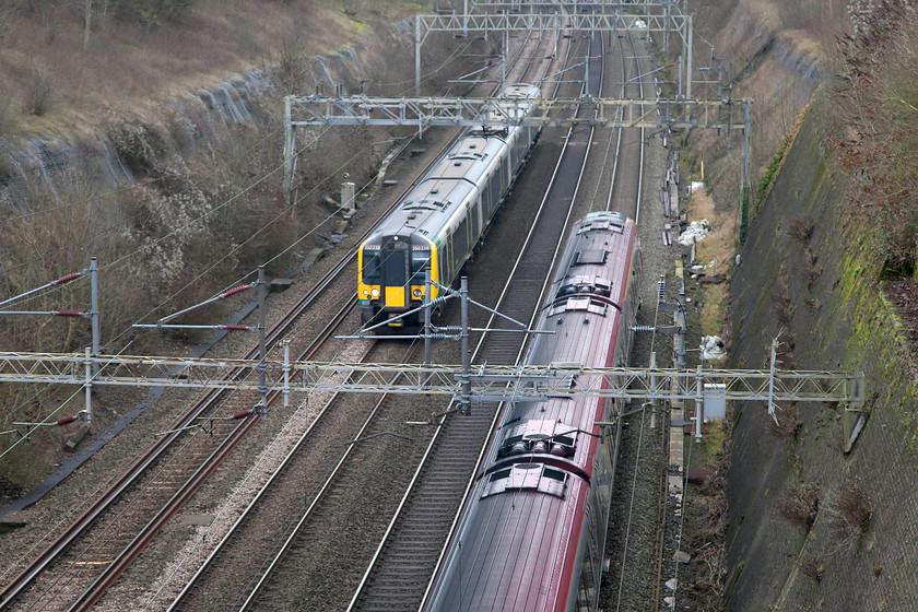 Class 221, VT 11.23 London Euston-Shrewsbury (9J17) & 350238, LM 10.54 London Euston-Northampton (2N39), Roade Cutting 
 A London Midland service is overtaken by a Virgin train in Roade Cutting. To the left, 350238 is working the 10.54 Euston to Northampton whilst a class 221 heads north forming the 11.23 Euston to Shrewsbury. 
 Keywords: Class 221 11.23 London Euston-Shrewsbury 9J17 350238 10.54 London Euston-Northampton 2N39 Roade Cutting