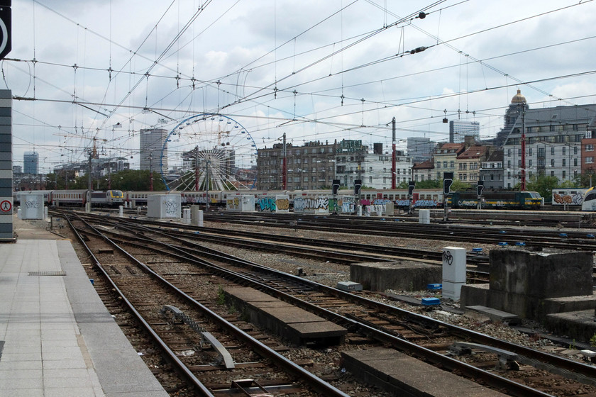 2717, 11.38 Antwerp Centraal-Brussels Midi (IC 3332) & 1890, 11.05 Turnhout-Binche (IC 3433), Brussels Midi station 
 Not a great picture but, I have included it because it includes one of Belgian Railways' class 27 locomotives. These are not particularly common on passenger work having been transferred to freight duties in 2007. It can bee seen heavily graffitied entering Brussesl Midi station working the 11.38 from Antwerp Centraal that will terminate here. Notice the ferris wheel in the background marking the arrival of the fair that was set up the entire length of the nearby Boulevard Du Midi 
 Keywords: 2717 11.38 Antwerp Centraal-Brussels Midi IC 3332 1890 11.05 Turnhout-Binche IC 3433 Brussels Midi station