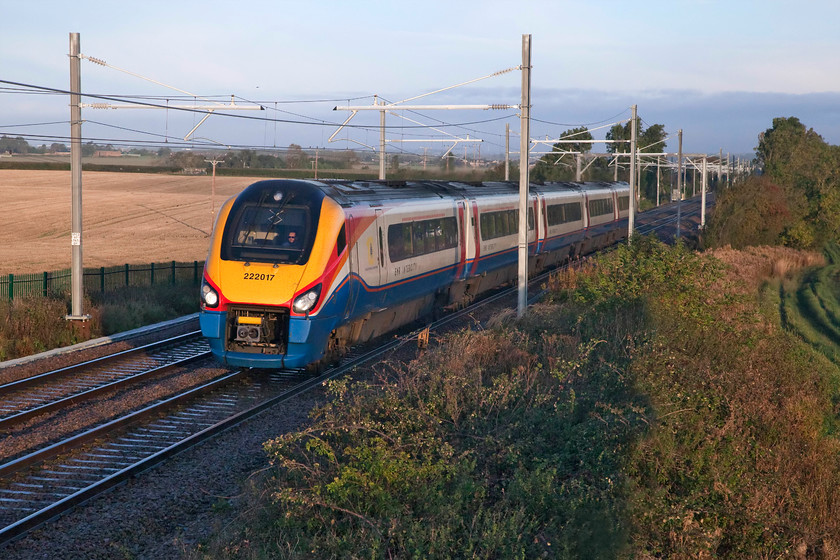 222017, EM 07.12 Nottingham-London St. Pancras (1B06, 2E), Wymington SP956634 
 Within less than a mile of this spot near the village of Wymington, Network Rail has closed three flat footpath crossings. The footpaths have been re-routed and now all converge on the footbridge on which I am standing. Unfortunately, it is one of their standard and hugely over-engineered green structures that offer few opportunities for photographers. 222017 climbs towards Sharnbrook summit with the 07.12 Nottingham to St. Pancras. The electrification wiring is all in place here but it is still some months away from being energised. 
 Keywords: 222017 07.12 Nottingham-London St. Pancras 1B06 Wymington SP956634