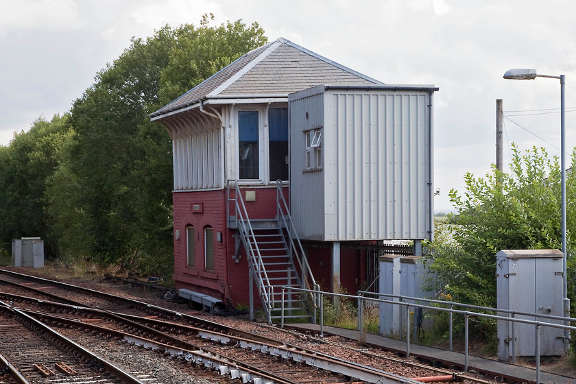 Barrhead signal box (Cal, 1894) 
 Barrhead signal box is seen from the platform end of the station. The huge and ugly carbuncle attached to the end of the 1894 Caledonian box serves a purpose I suppose but one wonders why a little more thought and effort could not have gone into its design and construction? Barrhead marks the start of the tokenless block section of line that continues all the way, becoming absolute block, as far as Annan. 
 Keywords: Barrhead signal box