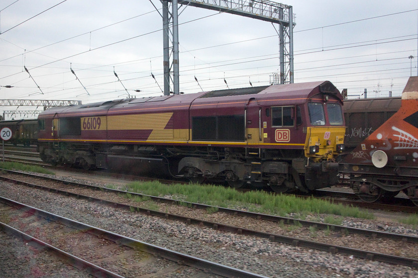 66109, down stone train, Wembley Yard 
 Passing Wembley Yard 66109 is seen at the head of a stone train. Notice that it has lost its EWS branding with it being subtly covered over with a DB vinyl. 
 Keywords: 66109 Wembley Yard