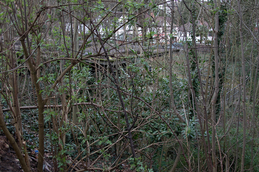 Canopies and platforms, former Highgate station 
 Taken over the wall from the small carpark at Highgate tube station the canopies of the former railway station can be seen through the encroaching undergrowth. Opened in 1880 by the Great Northern Railway, the station was re-built in 1935 as part of the 'new works' plan hence its prefabricated concrete construction. 
 Keywords: Canopies and platforms former Highgate station