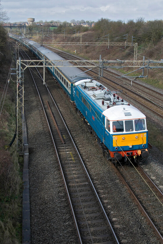 86259, 09.24 Liverpool South Parkway-Wembley Central (1Z86, 62L), Victoria bridge 
 The second football charter operated by WCR should have passed this spot just five minutes after the first one operated by LSL. Unfortunately, something went badly wrong before the train left Merseyside with it being diverted away from its usual route via Runcorn to take the Chat Moss line via Newton-Le-Willows to Winwick Junction from where it lost more and more time. Passing Victoria bridge over an hour adrift the now repaired 86259 'Les Ross/Peter Pan' leads the 09.44 Liverpool South Parkway to Wembley Central running, appropriately, as 1Z86. In an effort to make up some time, signallers have pathed it on the fast line via Weedon rather than taking it through Northampton. Despite the late running, Liverpool supporters will have arrived in time for the start of the match at Wembley but might well have missed out on some pre-match entertainment. 
 Keywords: 86259 09.24 Liverpool South Parkway-Wembley Central 1Z86 Victoria bridge Peter Pan Les Ross