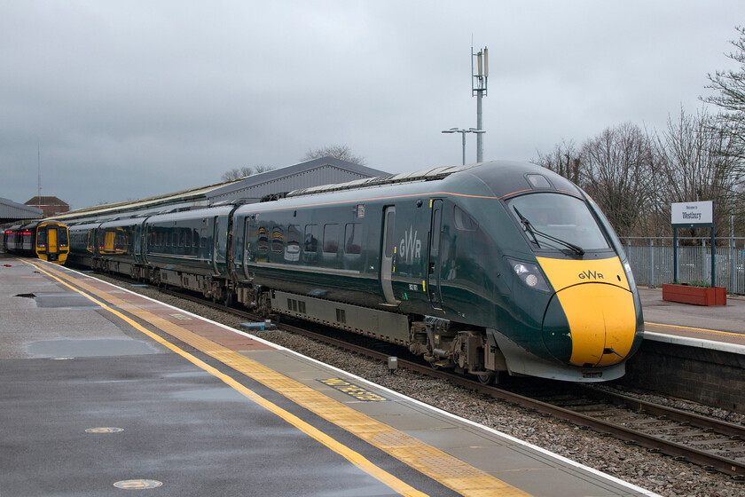 802001, GW 10.35 London Paddington-Exeter St. David's (1C77, 13L) & 158765, GW 12.17 Westbury-Swindon (2M17, 4L), Westbury station 
 Under threatening skies at Westbury station, the 10.35 Paddington to Exeter train has just come to a halt being worked by 802001 with 802022 out of sight behind the local unit. For some unexplained reason, the IET stood at the platform for some ten minutes that was odd as no other traffic appeared to be impinging on its route as it headed west. This delay was never made up, despite plenty of slack in its timings with it arriving at St. David's some thirteen minutes adrift. GWR's 158765 sits at platform three waiting to work the 2M17 12.17 local service to Swindon. 
 Keywords: 802001 10.35 London Paddington-Exeter St. David's 1C77 158765 12.17 Westbury-Swindon 2M17 Westbury station GWR IET