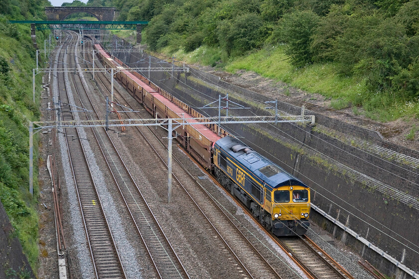 66743, 14.33 Garston Car Terminal-Dagenham Docks (6L48), Roade cutting 
 The 14.33 Garston car terminal to Dagenham docks empty car transporter makes its way through Roade cutting. Along with the European cargo wagons, these cartic wagons are extremely noisy when being hauled empty. GBRf's 66743 is hauling the 6L48 train that will be a relatively easy task being unloaded. 
 Keywords: 66743 14.33 Garston Car Terminal-Dagenham Docks 6L48 Roade cutting GBRf