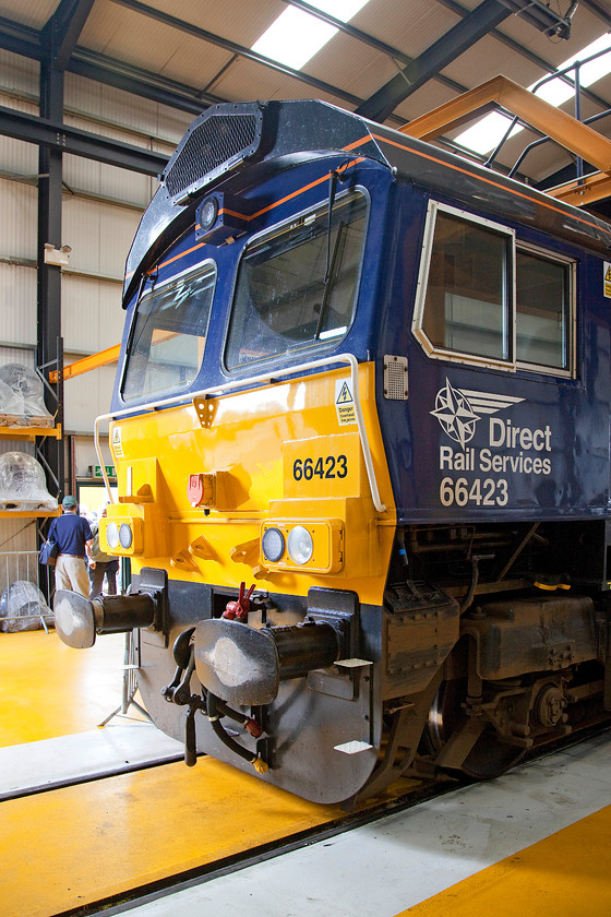 66423, on-display, DRS Gresty Bridge 
 A depot today is a very different place to what it was in the 1970s! The floor inside DRS's Gresty Bridge is so clean you could eat your lunch off it! Maybe the staff had done a through clean-up for the occasion but I think that there is a different approach to how work environments like this are managed in today's H & S orientated world. 66423 has been a DRS locomotive since it arrived on UK shores in September 2007. 
 Keywords: 66423 DRS Gresty Bridge