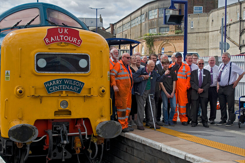 Harry Wilson, 55009 (55013), Scarborough station 
 Apart from the Detic, the real star of the show at Scarborough station was one-hundred-year-old Harry Wilson. Here he waves his cap to the gathered masses recording the occasion like myself. He was a top link driver first with steam and then with Deltics on the ECML until retirement. Retiring to and still living in York he always stated that 55013 'The Black Watch' was his favoured member of the famous twenty-two. As well as carrying a headboard in his name 55009 'Alycidon' was renumbered 55013 and named 'The Black Watch' for the day leading the outward and return Deltic Coronation charter from King's Cross to Scarborough where this photograph was captured. 
 Keywords: Harry Wilson 55009 55013 Scarborough station Alycidon The Black Watch