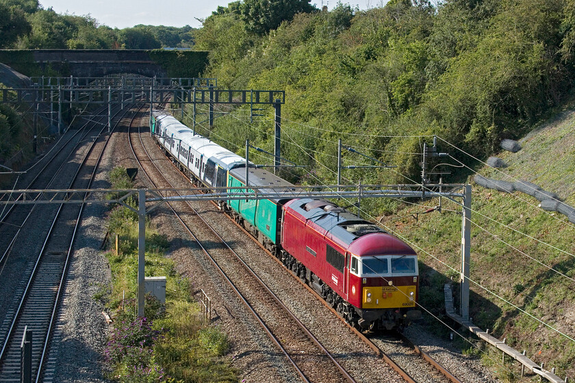 69009 & 458410, 13.11 Widnes Transport Tech-Wembley Yard (5Q62, RT), A508 bridge 
 I am going to take some time getting used to the look and livery of the re-purposed Class 56s! 69009 now named 'Western Consort' takes its name from the former Western Region hydraulic D1065 that I last photographed in 1977 on the scrap lines at Swindon, see..... https://www.ontheupfast.com/p/21936chg/23615749804/d1057-western-pathfinder-d1001-western. The 'new' locomotive is seen passing through Roade leading the 13.11 Widness Transport Tech to Wembley Yard stock move transferring SWR's 458410 back to its Southern haunts. The unit has been extensively refurbished by Alstom with it returning to its original four-car formation. On either side of the unit is a pair of former Class 508 EMUs now used as translator coaches, the leading one is 64707 'Labezerin' with 64664 'Llwet' at the rear. 
 Keywords: Western Consort 69009 458410 13.11 Widnes Transport Tech-Wembley Yard 5Q62 A508 bridge Labezerin