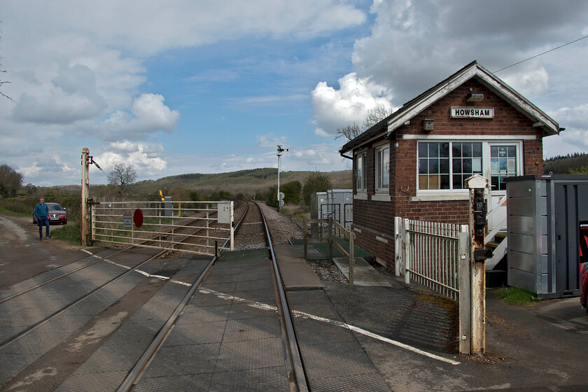 Howsham crossing & signal box (NE, C 1873) 
 Under dramatic skies Howsham signal box and level crossing are seen looking roughly east. The box has manually operated gates that involves the signalman leaving the box and closing the gates across the minor road. Once the gates are closed to road users the signaller returns to the box and pulls the levers to lower the signals. According to the SRS this very old box, along with the remaining five on this section of line, will be abolished in 2026 - so get there soon to get your photographs! 
 Keywords: Howsham crossing & signal box NE North Eastern Railway