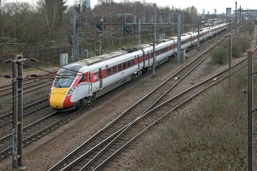 801103 & 801112, GR 12.03 London King`s Cross-Leeds (1D13, RT), Parkland Walk Finsbury Park footbridge 
 A little obscured by some registration arms, 800103 and 800112 get into their stride just north of Finsbury Park station woking the 12.03 King's Cross to Leeds LNER service. Behind the trees to the left is Finsbury's park, a very popular resource for locals if the number of people crossing the footbridge on which we were standing was anything to go by. Notice inner London dominating the skyline with The Shard standing taller than the other buildings. 
 Keywords: 801103 801112 12.03 London King`s Cross-Leeds 1D13 Parkland Walk Finsbury Park LNER Azuma footbridge