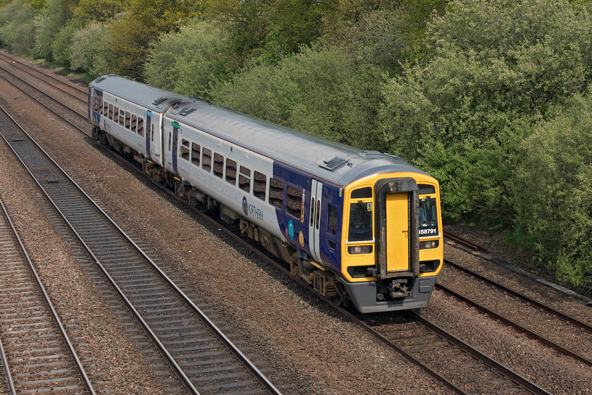 158791, 14.42 Hull-Doncaster (2C66, 2E), Cuckoo bridge SE660116 
 With the sun just back out again between torrential showers a Northern Express Sprinter in the form of 158791 passes Cukoo bridge near Stainforth working the 14.42 Hull to Doncaster local service. Dating from 1990 these BREL built units have proved to be reliable in operation and for a design that is over thirty years old they are still going well! 
 Keywords: 158791 14.42 Hull-Doncaster 2C66 Cuckoo bridge SE660116 Northern Express Sprinter