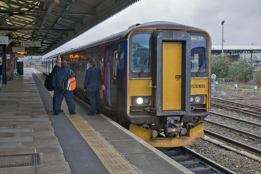 153305, GW 08.53 Weymouth-Bristol TM (2V88), Westbury station 
 A hybrid DMU pairing pauses at Westbury station. With single car 153305 leading a Class 150 they will work forward as the 08.53 Weymouth to Bristol Temple Meads. Whilst it is not yet raining, the grey and leaden sky is a portent of things to come for the rest of the day! 
 Keywords: 153305 GW 08.53 Weymouth-Bristol TM 2V88 Westbury station