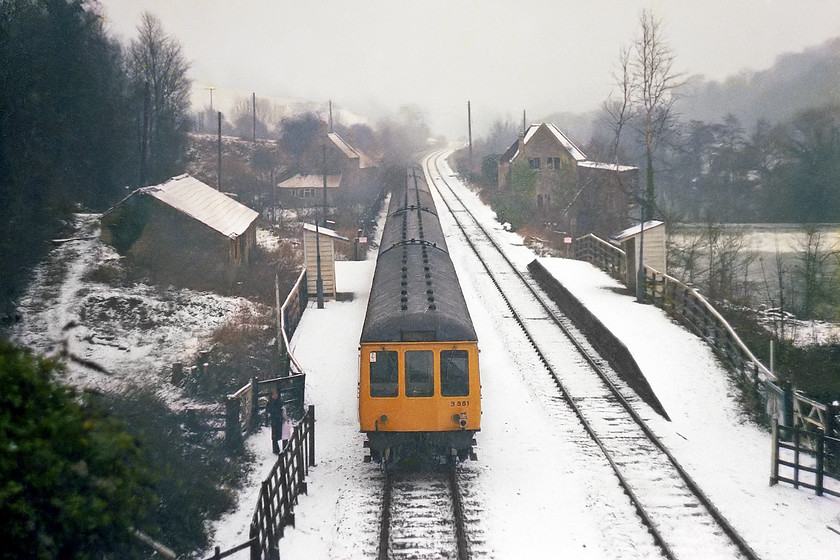 B581, 12.15 Bristol Temple Meads-Weymouth, Avoncliff station 
 A six-car DMU combination with class 119 set B581 on the rear pauses at Avoncliff halt. With a six-car DMU the arrangements for alighting passengers were a little long winded. Initially, the middle coach of the front set would be stopped at the platform for passengers from the front set to alight. Then, the guard would call the train on enabling anybody to alight from the rear set. The guard would sometimes also take the opportunity to join the other half of the train in order to complete his ticket inspection. The photograph is taken from the Avoncliff Aqueduct that spans the entire valley carrying the Kennet and Avon canal and a small road over the railway and the river allowing access to the excellent Cross Guns pub that was obviously of no interest to me in 1978! 
 Keywords: B581 12.15 Bristol Temple Meads-Weymouth Avoncliff station