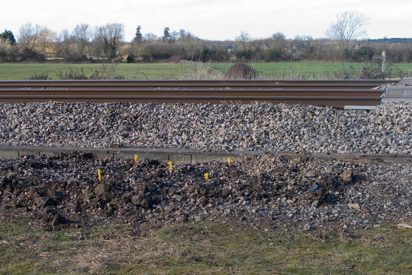 Position of electrification mast marked out, South Marston foot crossing SU196870 
 The early stages of the GWML electrification process have begun at Long Marston just east of Swindon. Using surprisingly low tech. methods, the location of just one of the many thousands of masts to be installed along the route from Paddington is shown using yellow plastic pegs! Along with the MML this route is last of the UK's trunk routes that remain free of electrification paraphernalia. 
 Keywords: electrification mast South Marston foot crossing SU196870