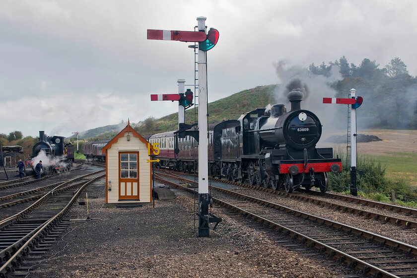 53809, 10.15 Sheringham-Holt & 564, Weybourne station-15.10.23 
 The North Norfolk Railway's first steam service of the day arrives at Weybourne station. It is an optical illusion that appears to show the line dropping as it approaches Weybourne station from the east but it is in fact a slight climb necessitating locomotives to be under power as they approach the station until abruptly shutting off as they pass the start of the patform. Former S & D 7F 53809 is doing this as it approaches with the 10.15 Sheringham to Holt service as GE 0-6-0 564 redies itself to head off to Sheringham to haul the Sunday lunchtime dining train a little later. 
 Keywords: 53809 10.15 Sheringham-Holt 564 Weybourne station-15.10.23 Somerset and Dorset 7F