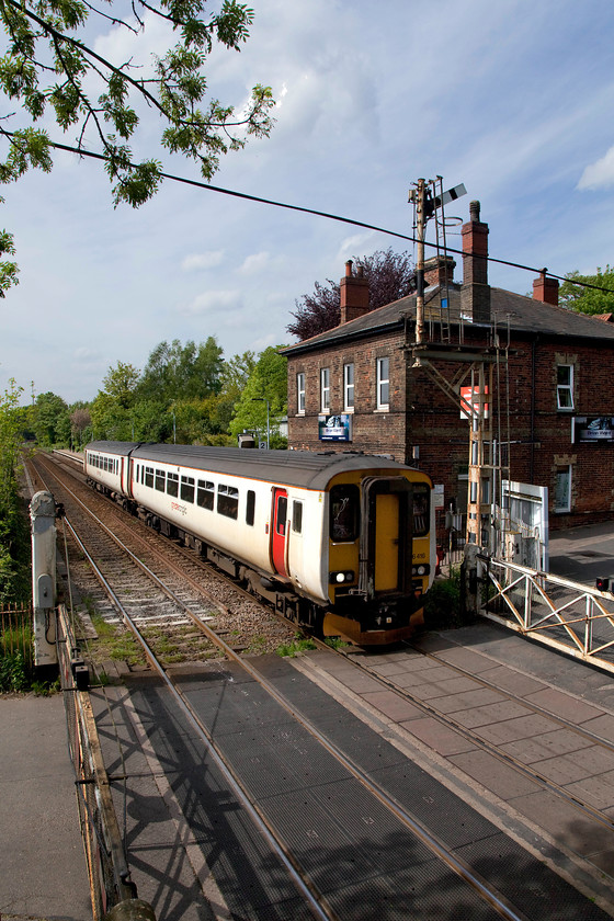 156416, LE 14.40 Norwich-Great Yarmouth (2P24, RT), Brundall station 
 In lovely spring weather, 156416 leaves Brundall station forming the 14.40 Norwich to Great Yarmouth (2P24) working. The down starter signal has been pulled off to permit passage of the train over the level crossing and forward towards Brundall Junction some short distance behind where I am standing on the footbridge. 
 Keywords: 156416 2P24 Brundall station