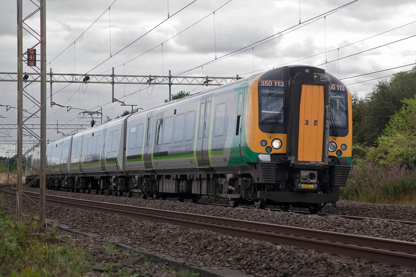 350113, LN 11.24 London Euston-Milton Keynes Central (2K43, 5L), Old Linslade 
 In a shot reminiscent of my 1970s 'low angle' pictures, 350113 passes Old Linslade working the 11.24 Euston to Milton Keynes Central. This image did need a little Photoshop 'manipulation' as the camera had exposed for the bright summer sky leaving the subject rather underexposed. After initial adjustments with levels, extensive use was made of the excellent shadows and highlights adjustments to bring a sense of normality back to the shot. 
 Keywords: 350113 2K43 Old Linslade