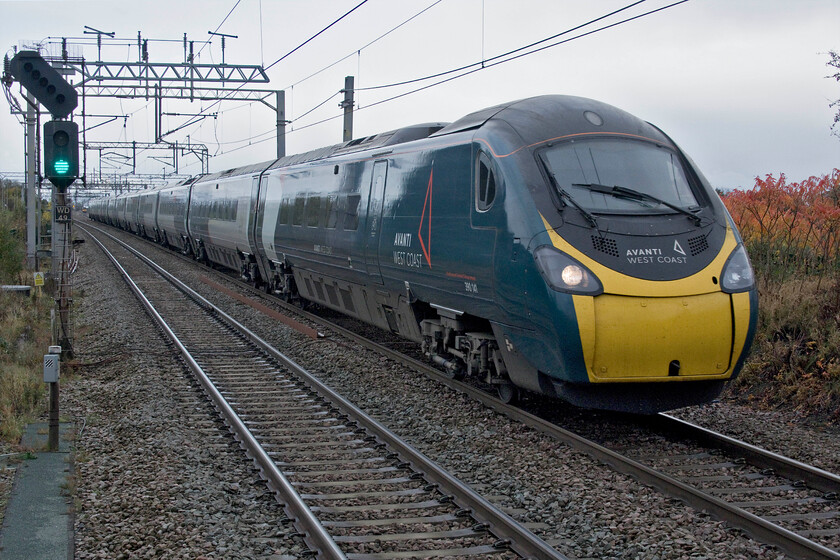 7. 390141, VT unidentified down working, Winsford station 
 Despite all of the technology available I have been unable to identify this northbound Pendolino working as it passes Winsford. Nothing in either RTT or Rail Record fitted the time or could place 390141 anywhere near this location and believe me I spent some time trawling through the data and exploring all sorts of strange scenarios that could have caused this! Notice the pair of light engine Class 66s sitting in the loop towards the rear of the mystery working waiting for access to the two-track section of the mainline that acts as a significant bottleneck between Winsford South to Weaver Junctions. 
 Keywords: 390141 unidentified down working Winsford station Class 390 Pendolino Avanti West Coast